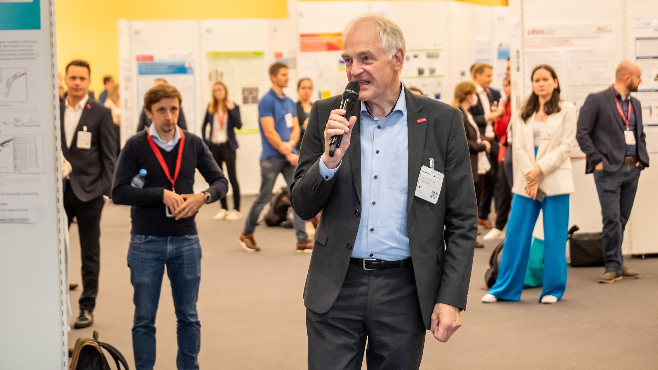 Man giving a speech in front of congress participants